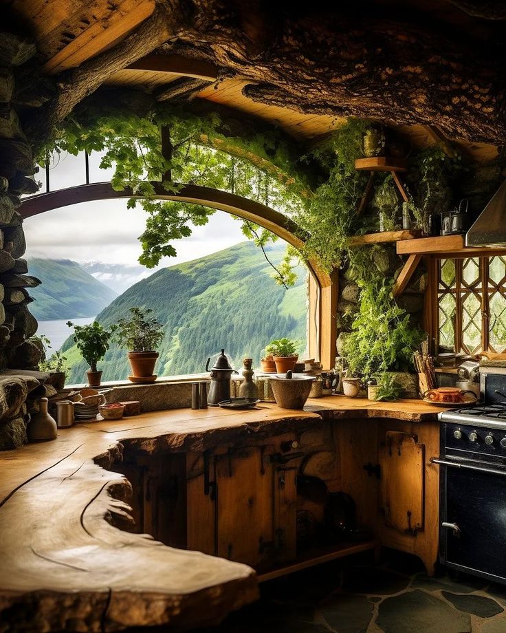 a kitchen with an arched window and wooden counter tops in front of a mountain view