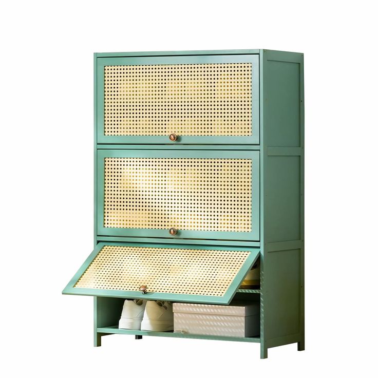 a green cabinet with two drawers and baskets on it's sides, against a white background
