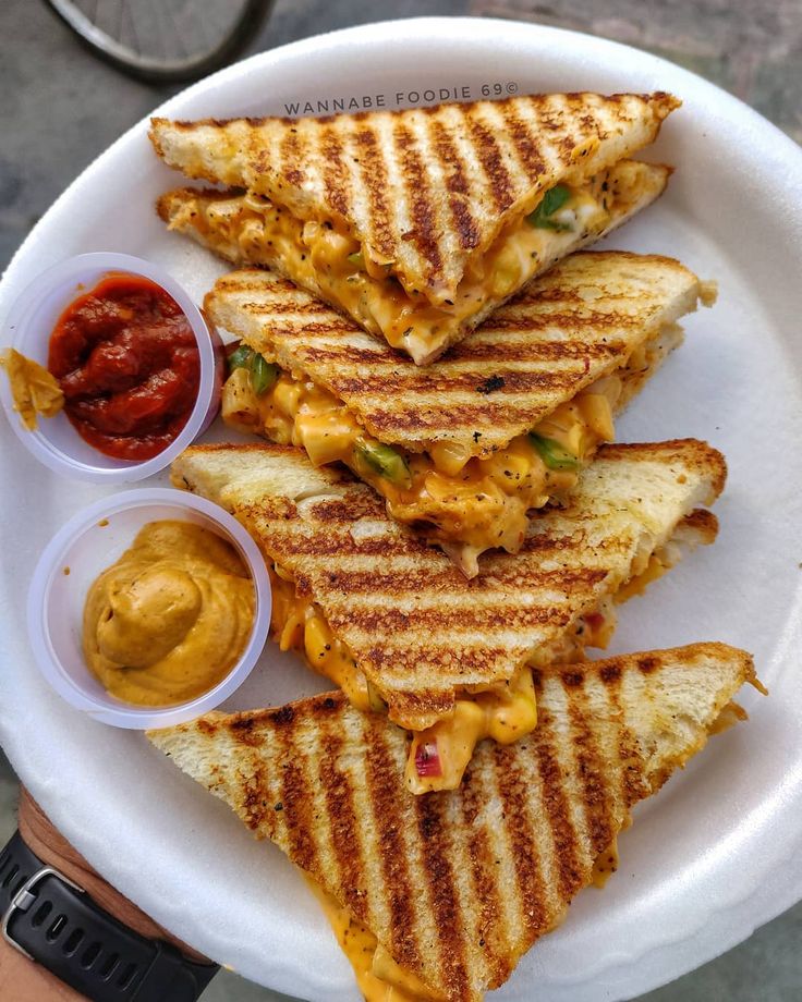 a white plate topped with grilled cheese sandwiches