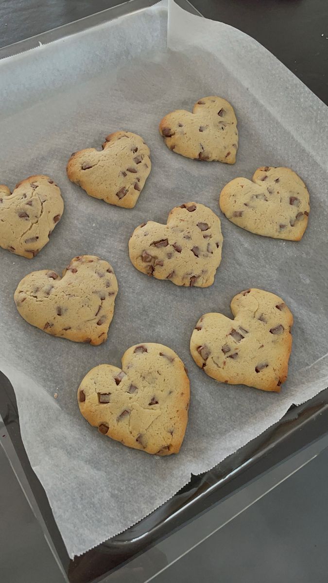 nine chocolate chip cookies in the shape of hearts
