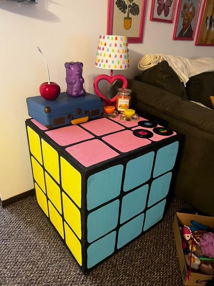 a rubik cube is sitting on the floor in front of a couch