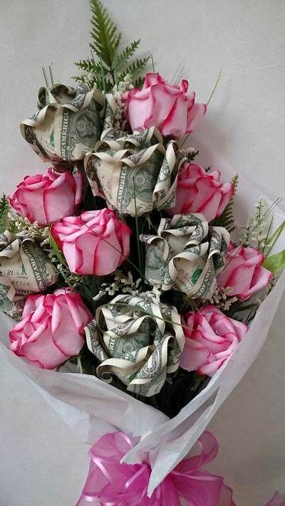 a bouquet of pink roses wrapped in dollar bills
