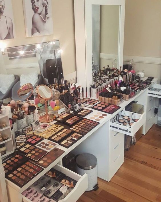 a room filled with lots of makeup on top of a wooden floor
