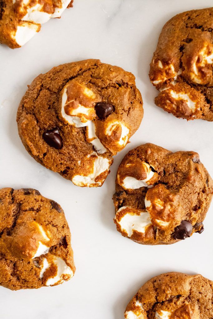 cookies with marshmallows and chocolate chips on a white surface, top view