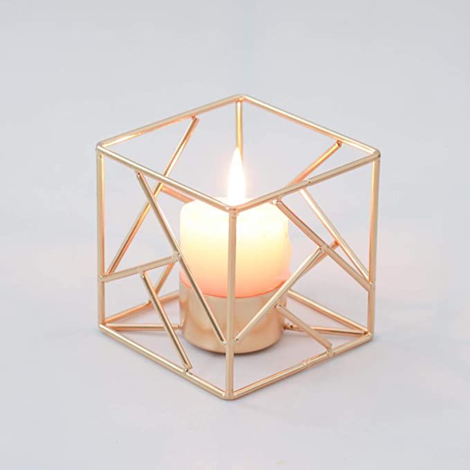 a candle that is sitting inside of a cube