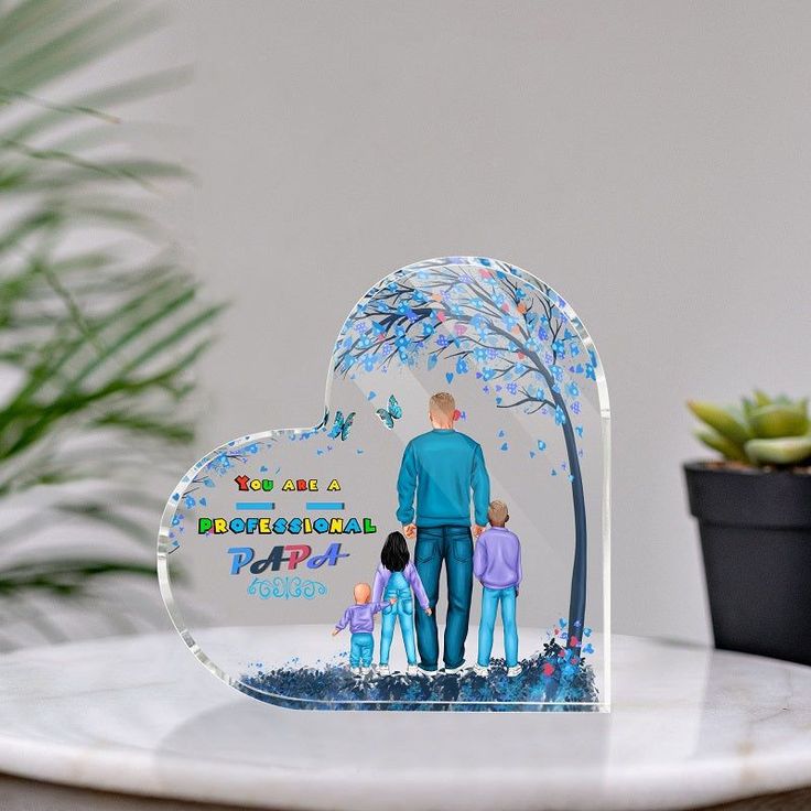 an acrylic figurine depicting a family standing under a tree