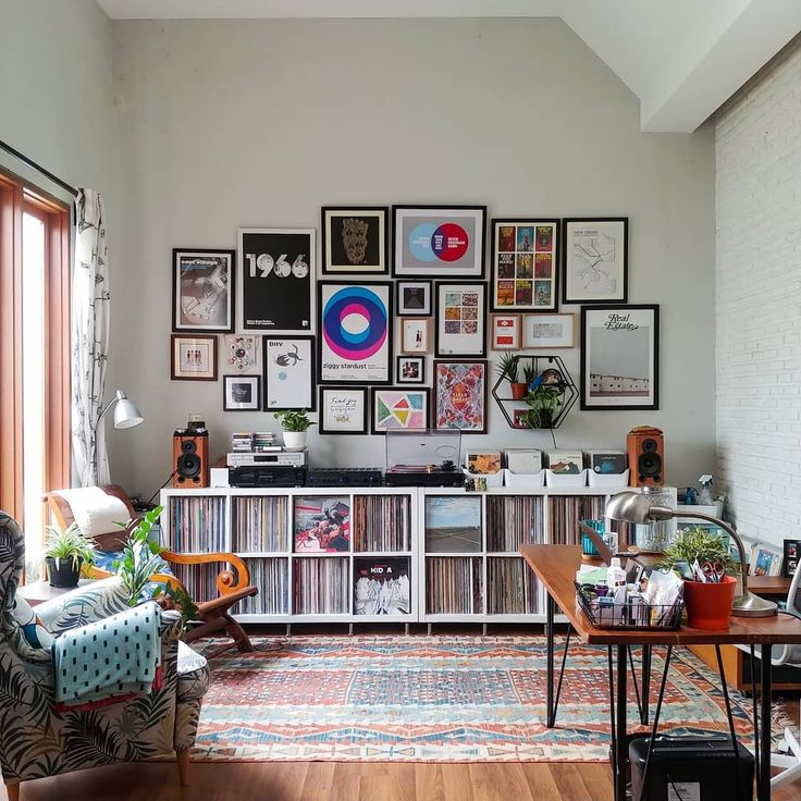 a living room filled with furniture and lots of pictures on the wall above it's bookshelf