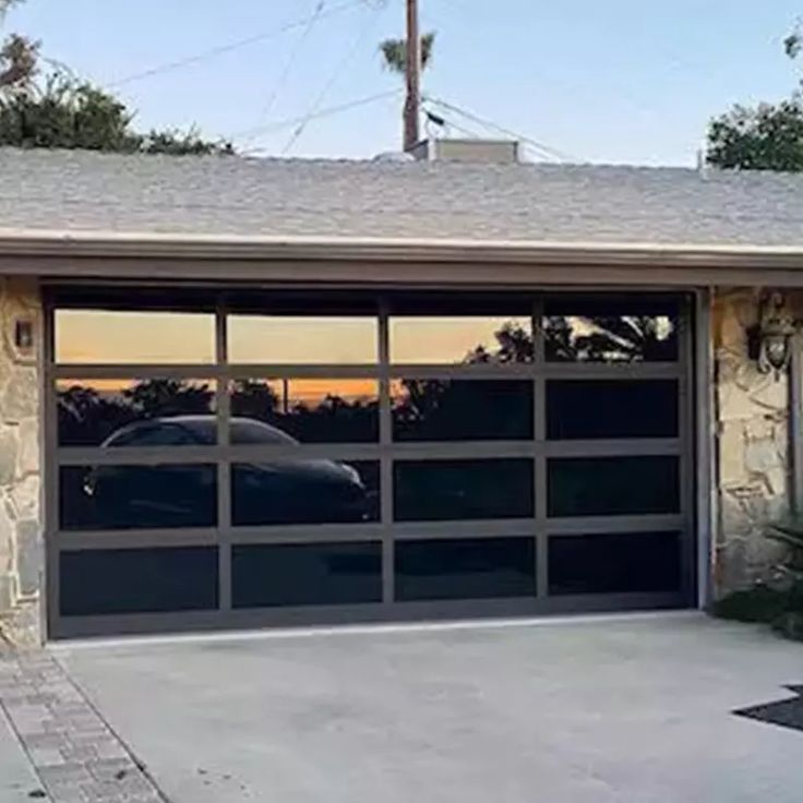 a car is parked in front of a garage