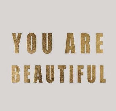 a black and white poster with the words you are beautiful in gold foil on it