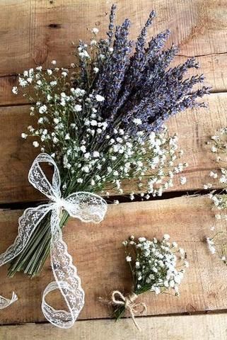 lavenders and baby's breath tied together on wooden planks with ribbon around them