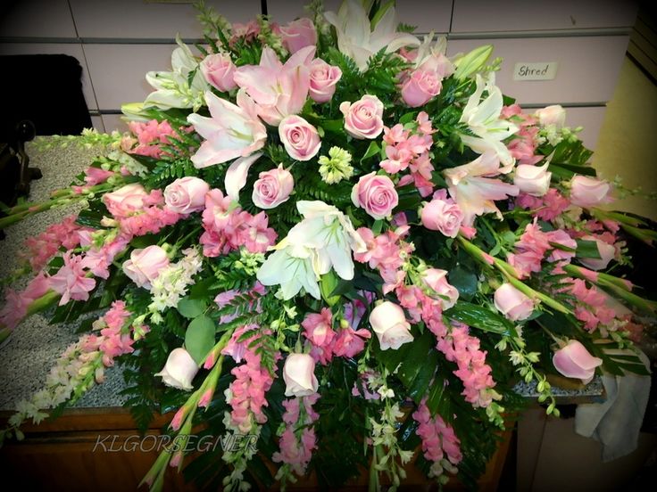 a bouquet of pink and white flowers sitting on top of a table