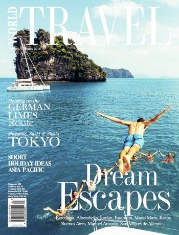 a magazine cover with a person jumping into the water from a boat in front of an island