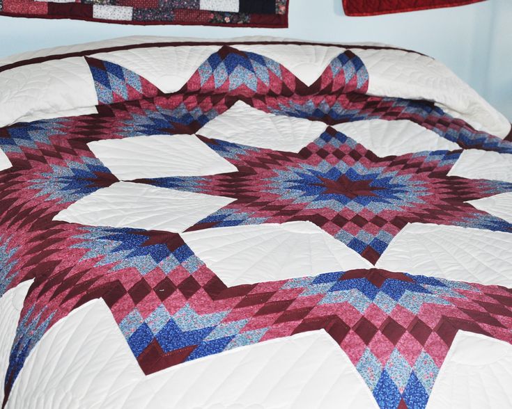 a quilted bedspread with red, white and blue designs