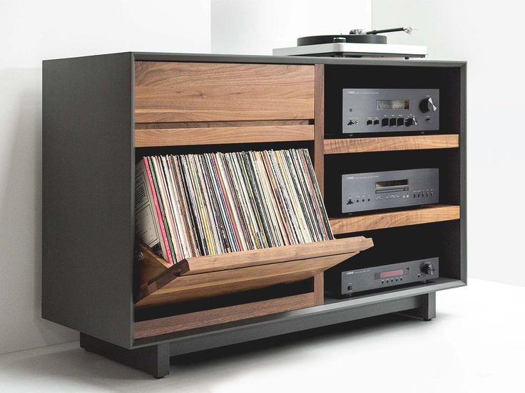an old record player is sitting on top of a cabinet