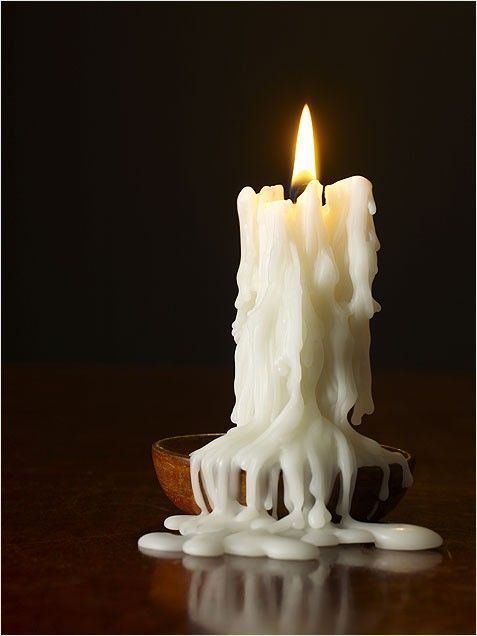 a lit candle with white icing on it
