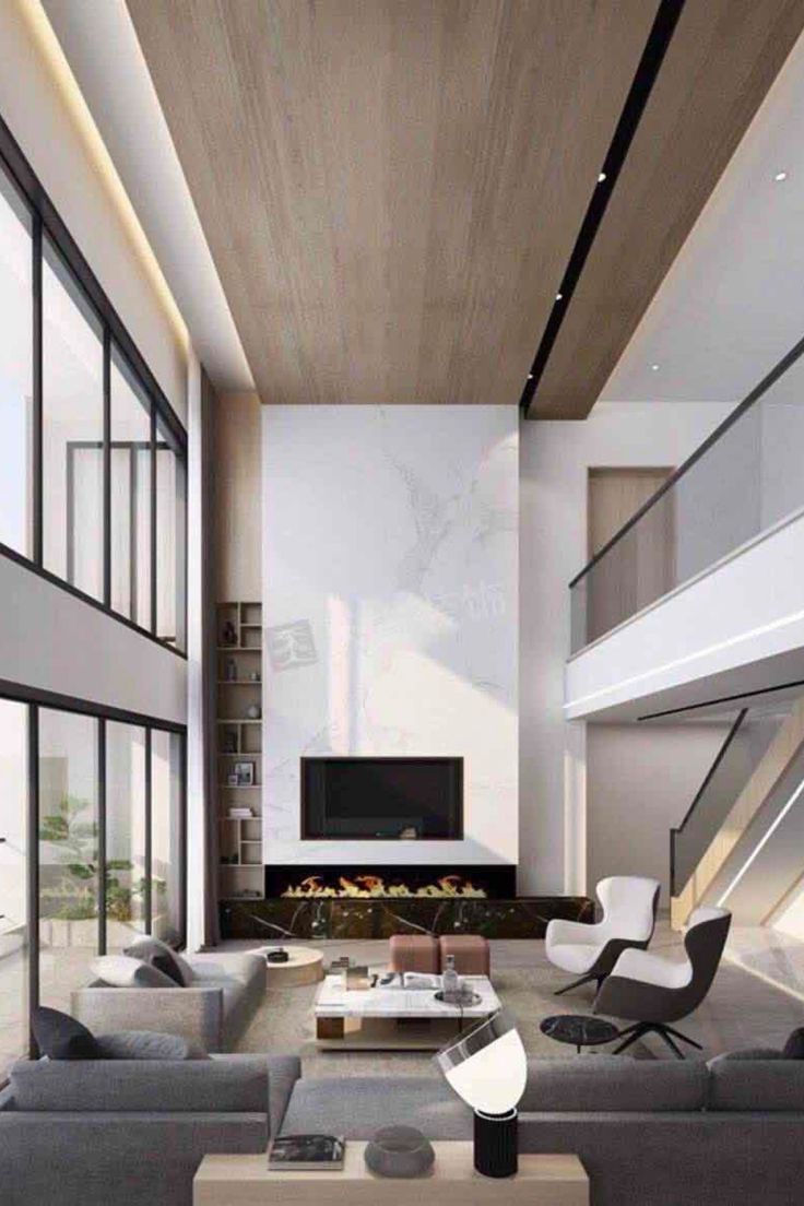 We're obsessed with this living room design. It has unique details and the perfect statement pieces! Find out the Best Interior Designers in New York City in the link below! #newyorkfurniture #newyorkart #newyorkarchitecture #newyorkproperty #newyorkdesigner Interior, Fireplace In Living Room, High Ceiling Living Room Modern, High Ceiling Living Room, Double Height Living Room, Modern Living Room, Interior Design Living Room, Living Room Modern, High Ceiling