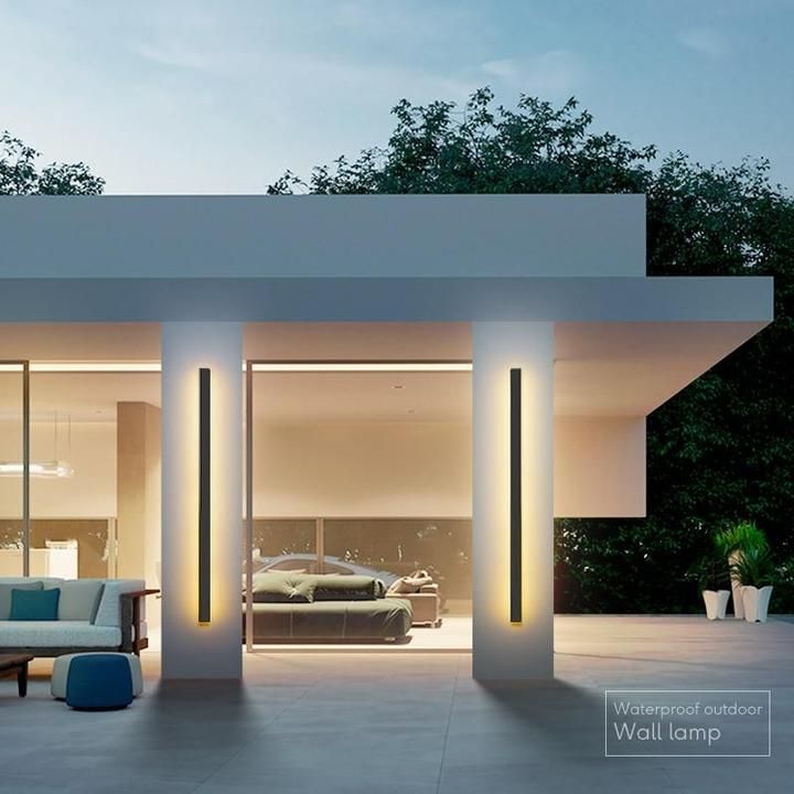 an outdoor living area with couches, tables and lamps on the side of it