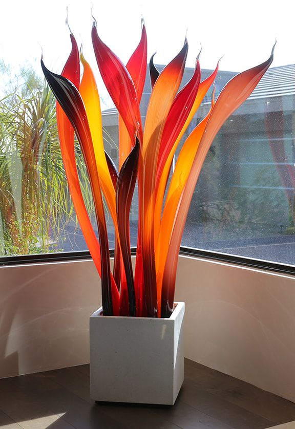 a large glass plant sitting on top of a window sill