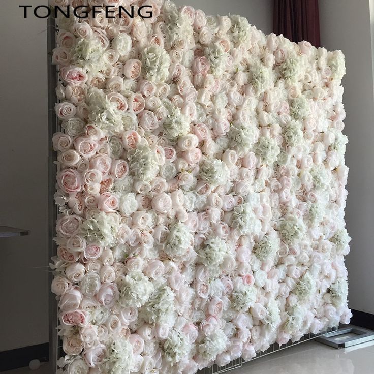a wall made out of pink and white flowers