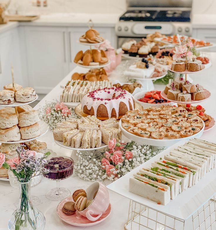 a table filled with lots of different types of cakes and pastries on it's sides