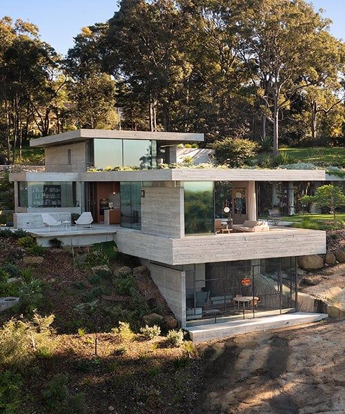 a modern house on the side of a hill