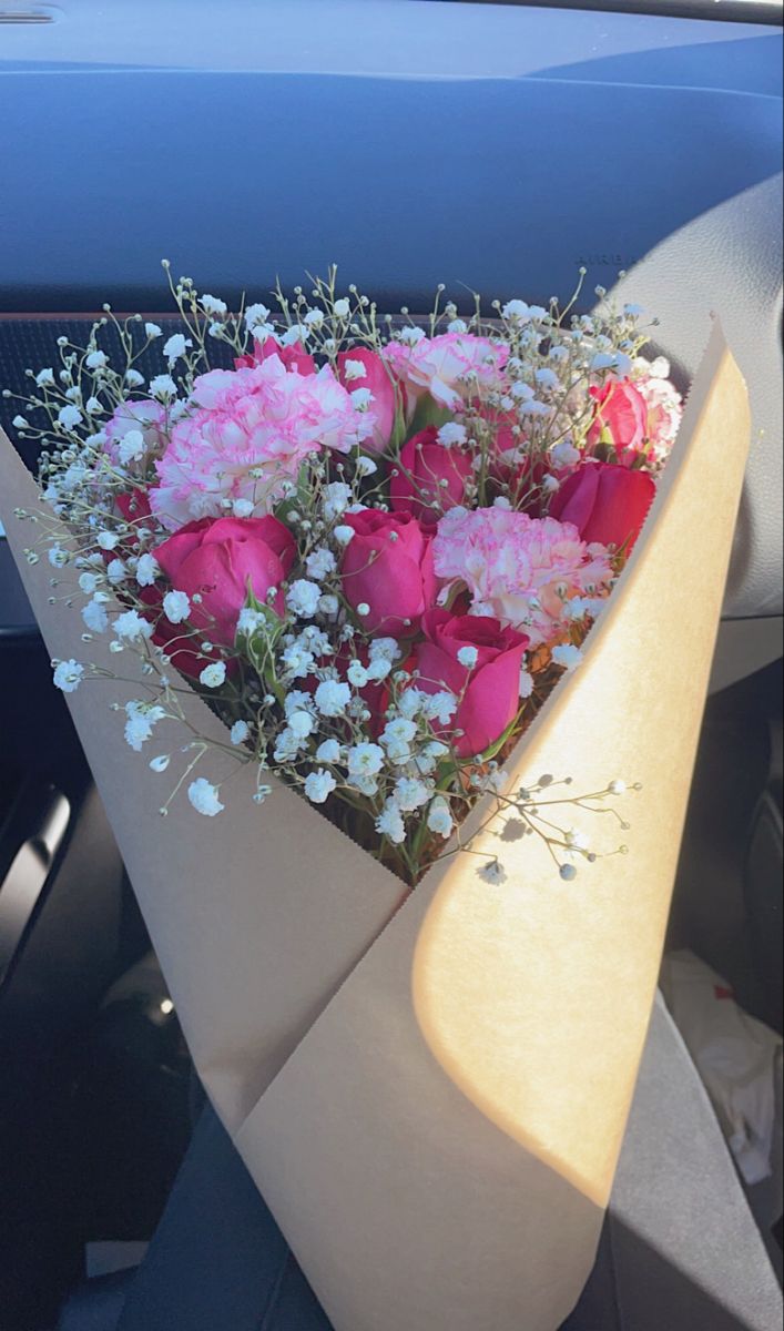 a bouquet of flowers sitting in the back seat of a car