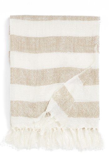 a white and beige striped towel with fringes