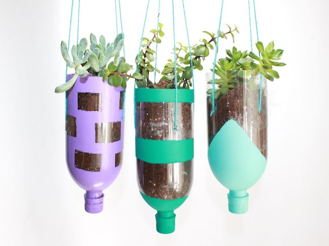 three hanging planters with plants in them