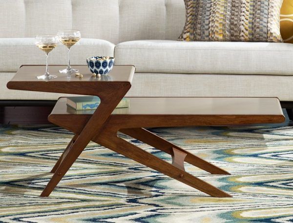 a coffee table sitting on top of a rug next to a couch