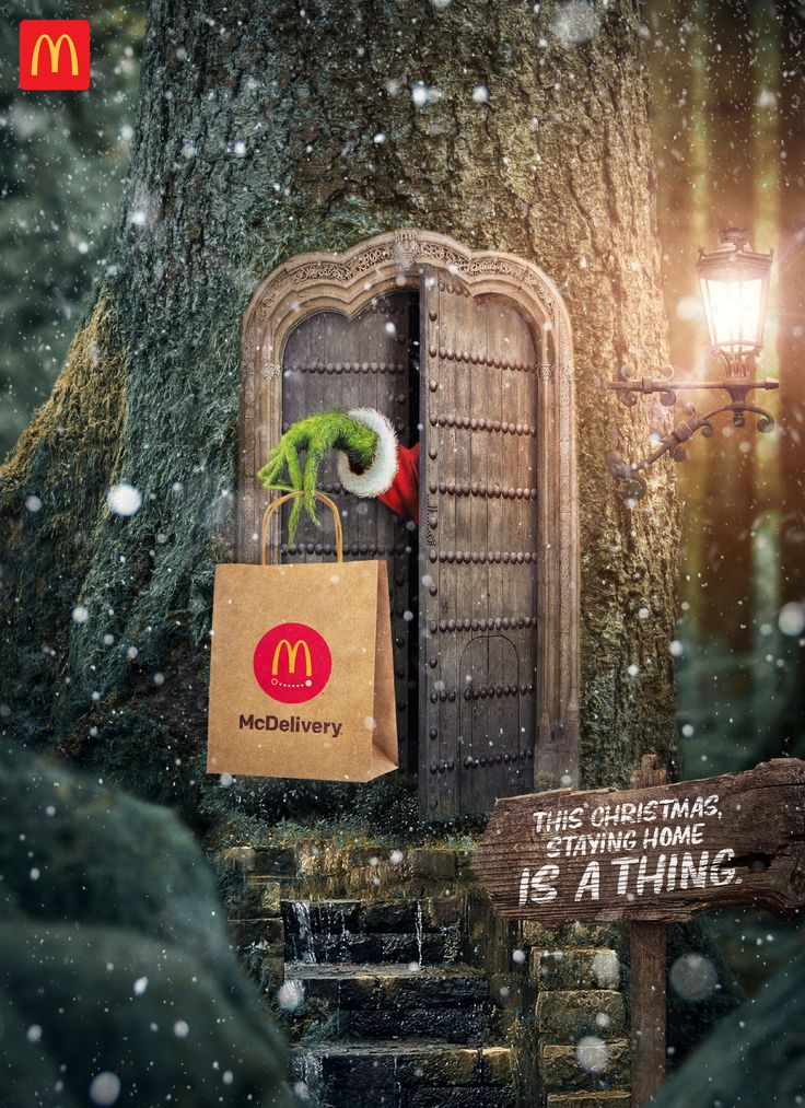 an advertisement for mcdonald's is displayed in front of a tree with a bag on it