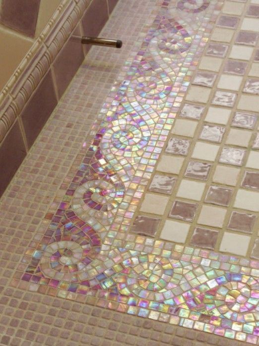 the bathroom floor is covered in colorful glass tiles