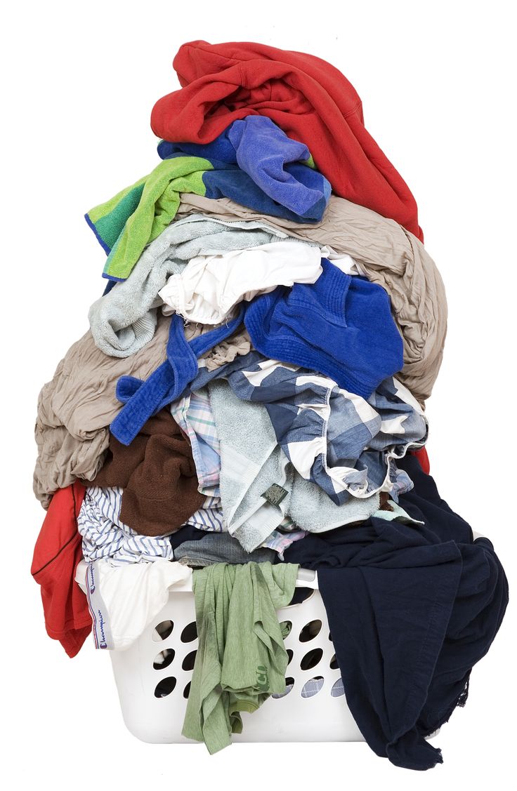 a pile of clothes sitting on top of a laundry basket