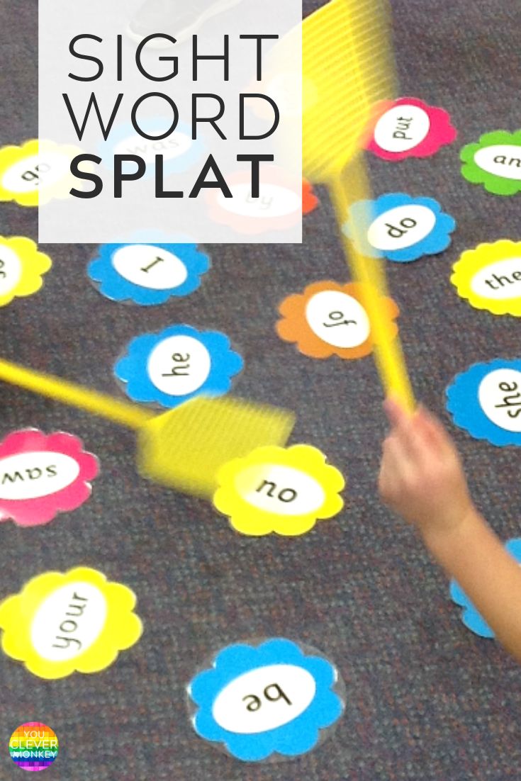 a child playing with sight word splat on the floor in front of some numbers