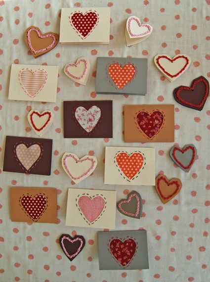 many small hearts are placed on top of each other in the shape of envelopes