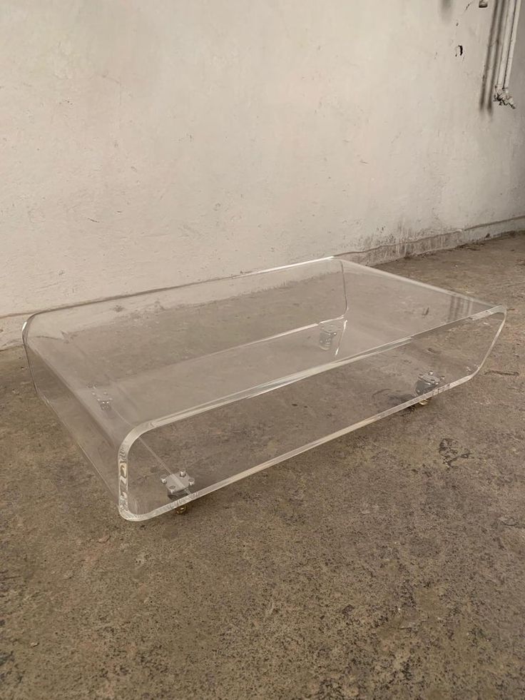 a clear plastic box sitting on the ground