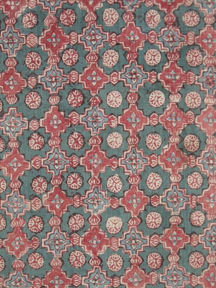 an old rug with red and blue designs on it