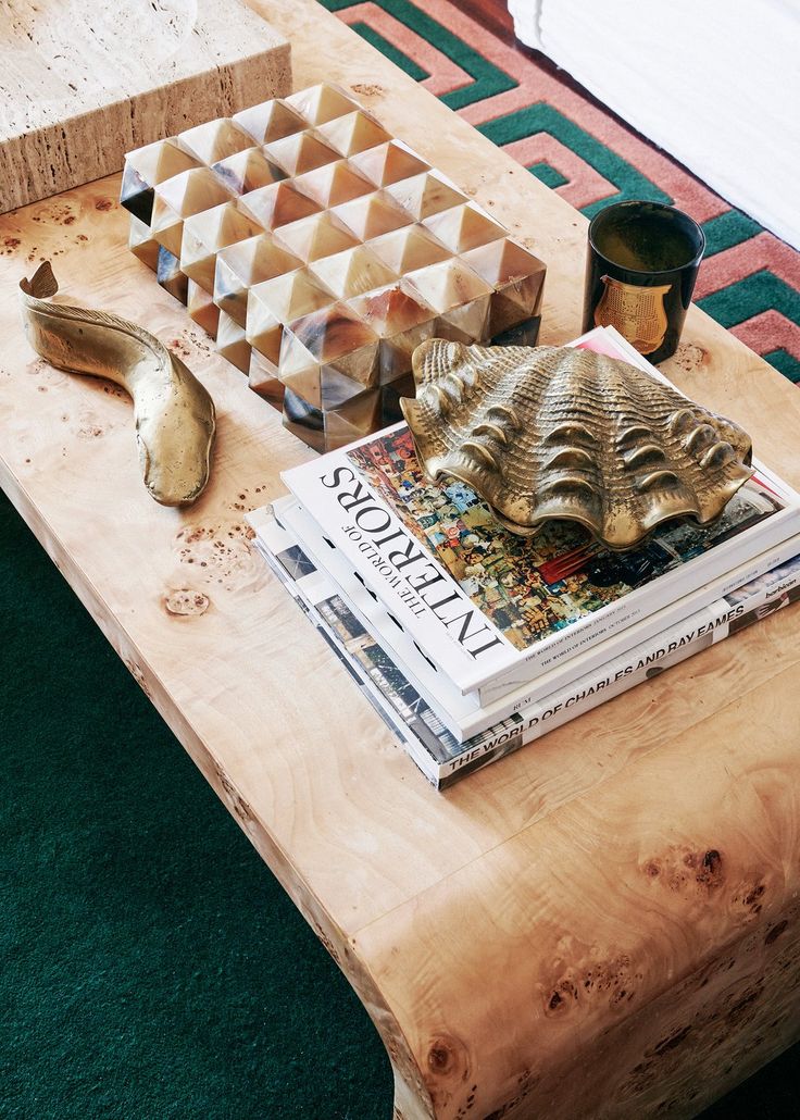 a wooden table with magazines and other items on it, including a coffee table made out of plywood