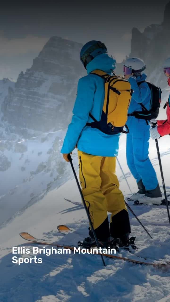 three skiers are standing on the side of a mountain looking out at the snow