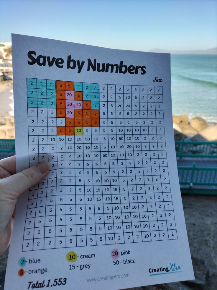 someone is holding up a printable sud puzzle to show the numbers they have on them