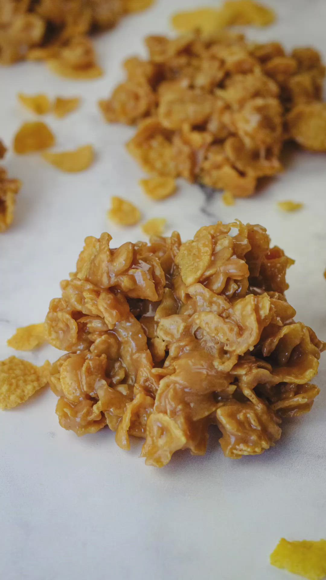 This may contain: peanut butter cornflake cookies on a white surface with the words, how to make peanut butter cornflakes
