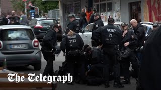 video: Watch: Axe-wielding man shot by police in Hamburg and England fans clash with Serbians – latest