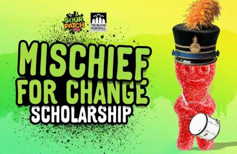 A vibrant Sour Patch Kid in a marching band hat holding a drum with the text "MISCHIEF FOR CHANGE SCHOLARSHIP" over a splattered green and yellow background, symbolizing the partnership with Thurgood Marshall College Fund.