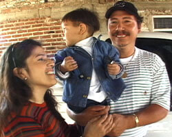 Photograph of Rosa, Miguel and their son.