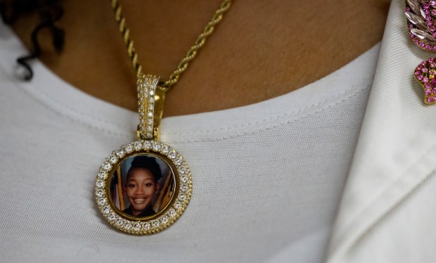 Sharon Pughsley wears a photo of her late daughter, Det. Tanisha Pughsley, who was killed in 2020 in Alabama on on May 12, 2024, during the 4th annual Heal Your Heart Mother's Day event at St. Elizabeth's Hall in Bronzeville. (Brian Cassella/Chicago Tribune)