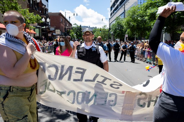 A Chicago police officer stands by while pro-Palestinian protesters briefly block the 53rd annual Chicago Pride Parade on June 30, 2024. (Vincent Alban/Chicago Tribune)