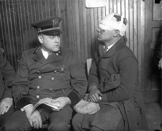 Cicero Chief of Police Albert W. Valecka, left, with one of dozens of people injured by roving bands of "sluggers," who intimidated, beat up and even kidnapped voters, election workers and campaign workers on election day in Cicero in 1924. (Chicago Tribune historical photo)
