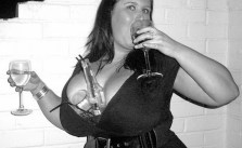 Funny Awkward Family Photos: Big Boobed woman drinking double fisted with drinks between her breasts