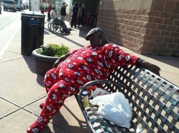 awkward family photo man in mickey mouse pajamas sleeping at bus stop bench