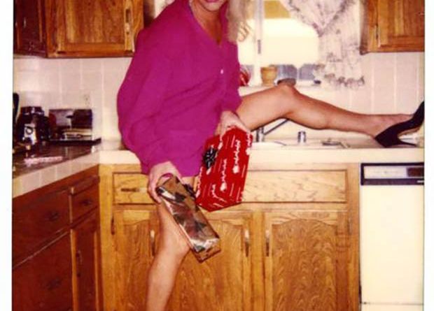 vintage family christmas photo 1980s, woman posing in kitchen trying to look sexy, holiday cards