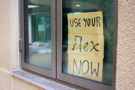 A sign on cardboard in a window that says 